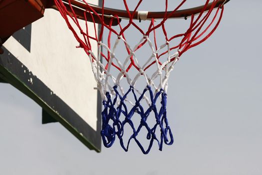 Aim high concept - basketball hoop with blue gradient background.