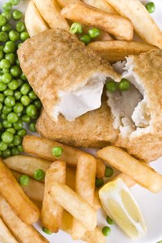 Fried fish and chips with lemon and peas