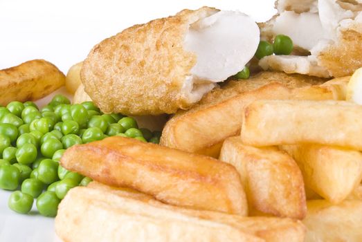 Fried fish and chips with lemon and peas - isolated