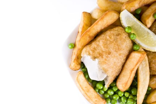 Fried fish and chips with lemon and peas - isolated