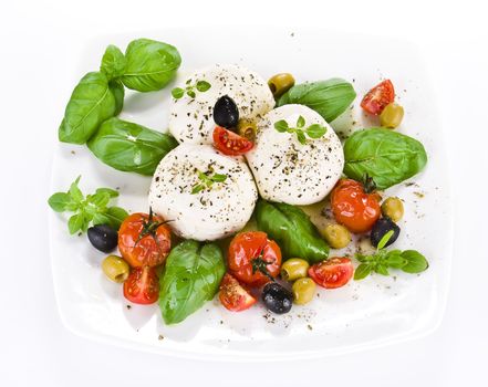 Mozzarella with fresh basil and  cherry tomatoes over extra virgin oil