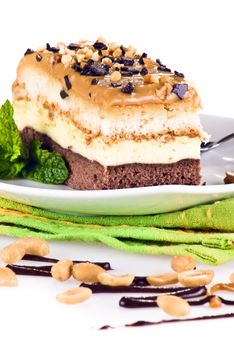 Freshly baked snickers cake on the plate isolated on white