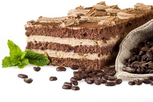 Tiramisu cake with bag of coffe beans isolated over white