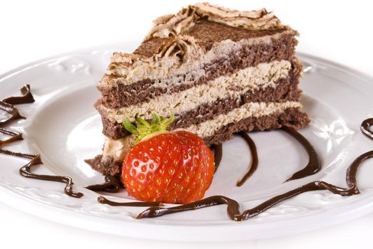 Tiramisu cake on plate with strawberry isolated over white