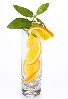 Slices of orange and mint in the glass isolated over white
