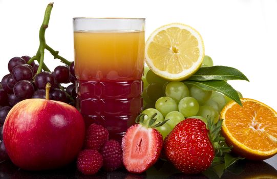 Glass of juice and friuts isolated over white