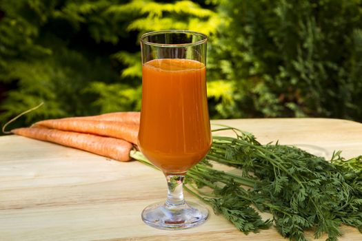 Glass of freshly made carrot juice with vegetables