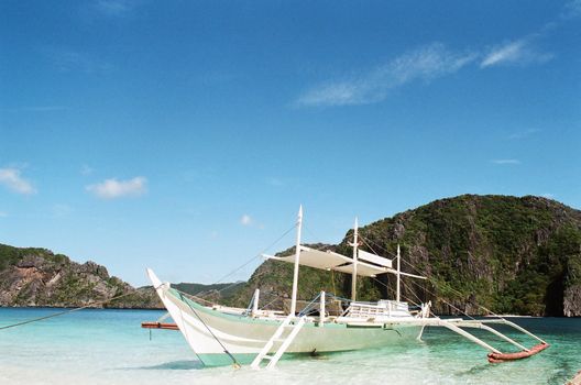 philippines tranditional boat, banca, docked  at shore.