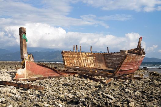Old rusty shipwreck in low tide coastline
