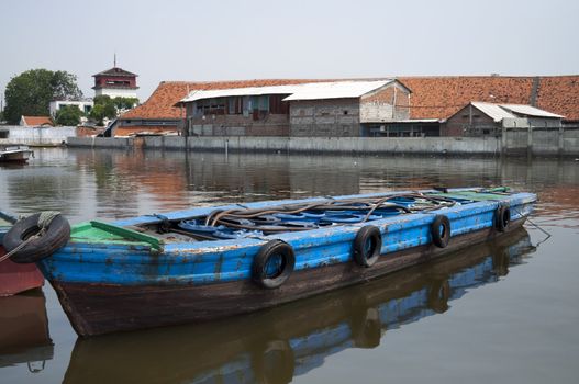 Rusty old boat in a river in Jakarta