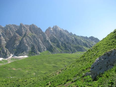 Mountains, rocks; a relief; a landscape; a hill; a panorama; Caucasus; top; a slope; clouds; the sky; a landscape