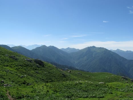 Mountains, rocks; a relief; a landscape; a hill; a panorama; Caucasus; top; a slope; clouds; the sky; a landscape