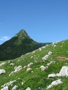 Mountains, rocks; a relief; a landscape; a hill; a panorama; Caucasus; top; a slope; clouds; the sky; a landscape