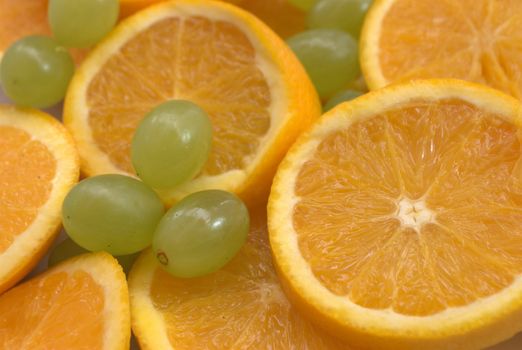 Slices of oranges and whole grapes