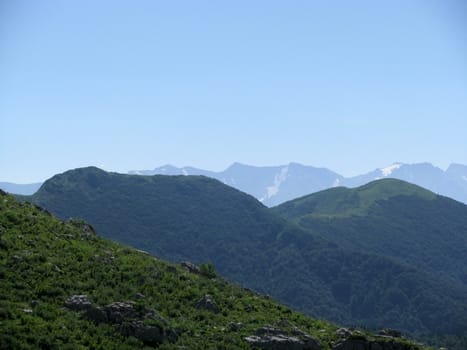 Mountains, rocks; a relief; a landscape; a hill; a panorama; Caucasus; top; a slope; clouds; the sky; a landscape