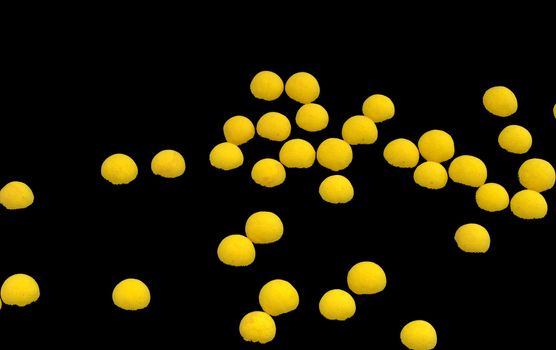 Group of bright yellow spheres on black background