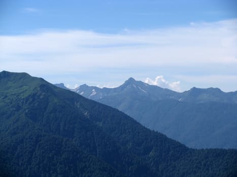 Mountains, rocks; a relief; a landscape; a hill; a panorama; Caucasus; top; a slope; clouds; the sky; a landscape