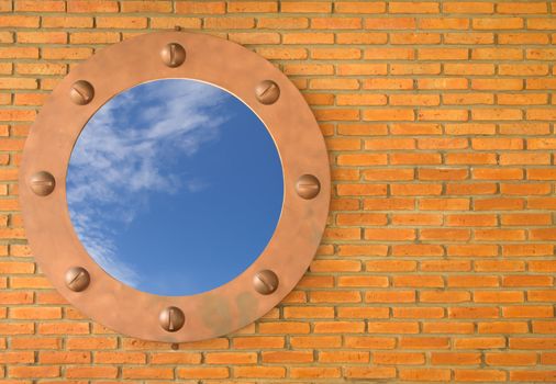Blue sky in hole in old wall, brick frame