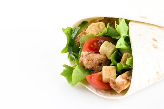 Tortilla filled with lettuce chicken tomatoes and cucumber