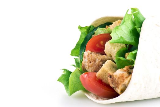 Tortilla filled with lettuce chicken tomatoes and cucumber