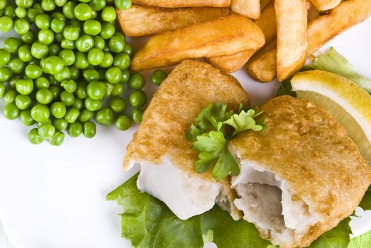 Fried fish and chips with lemon and peas