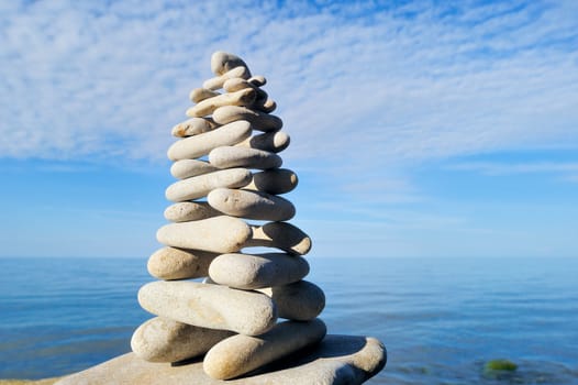 White long pebbles in the balance on the seacoast