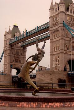 Tower Bridge in London, England. Statue of girl and dolphin.