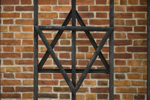 David's star over brick background in Cracow, Poland.