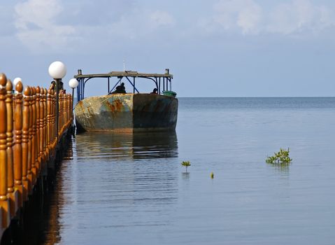 Old boat tied to a jetty in Cuba