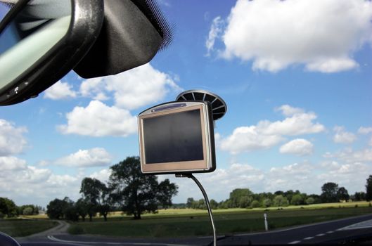 GPS on car window over blue sky