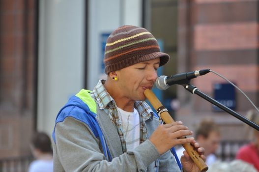 14 AUGUST YORK ENGLAND : Peruvian Busker Playing a Recorder Type Instrument in York City Centre to the Crowds on 14 August 2009