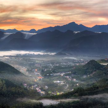 Rural scenery with forest and fog in morning under dramatic sunrise color in Taiwan, Asia.