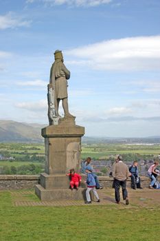 Tourists at Robert the Bruce Statue near Stirling Castle in Scotland UK
