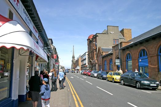 Shoppers in a Car Lined Street Ayr Scotland