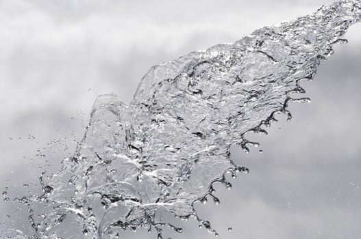 Water splash on a cloudy sky background