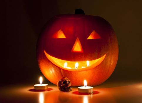 Halloween lantern and a small skull lit by candles