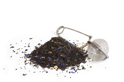 Scented tea and tea ball on white background