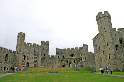Tourists at Caernarfon Castle in North Wales UK