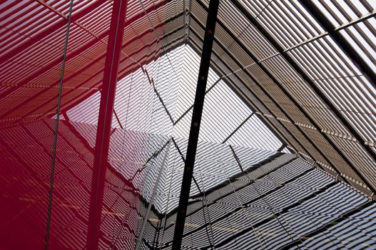 Modern building detail, metal structure reflecting on the glass