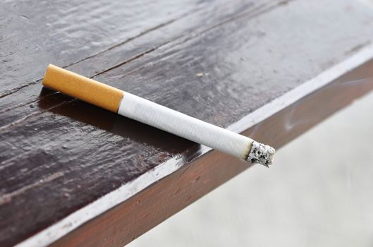 A cigarette on a wood table