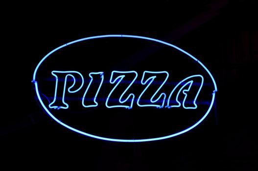 Blue neon pizza sign at night