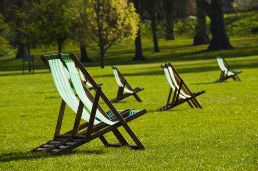 Deck chairs in a park in spring