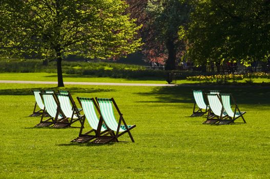 Deck chairs in a park in spring