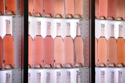 Rose wine bottles on shelves