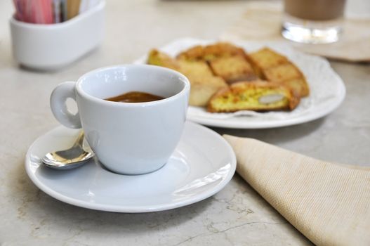 Espresso cafe and biscuits on a marble table, Italian way of life