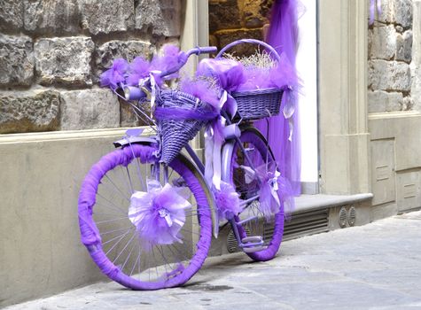 Vintage bicycle wrapped in purple fabric