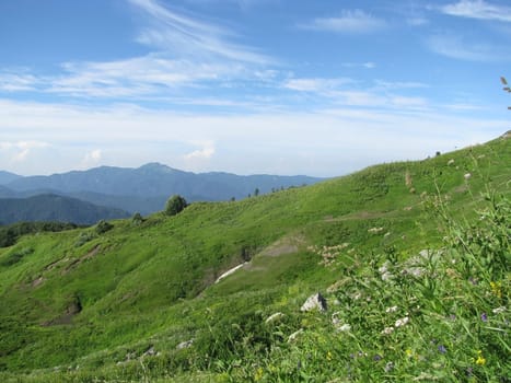 Mountains, rocks; a relief; a landscape; a hill; a panorama; Caucasus; top; a slope; clouds; the sky; a landscape