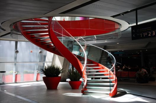 Red spiral staircase in an airport