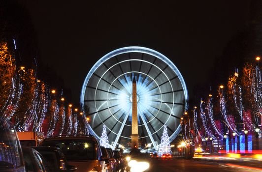 The Champs-Elysees avenue and the ferris wheel on Concorde Square illuminated for Christmas