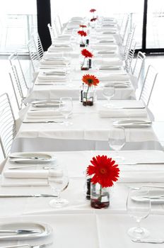 A white restaurant with red flowers